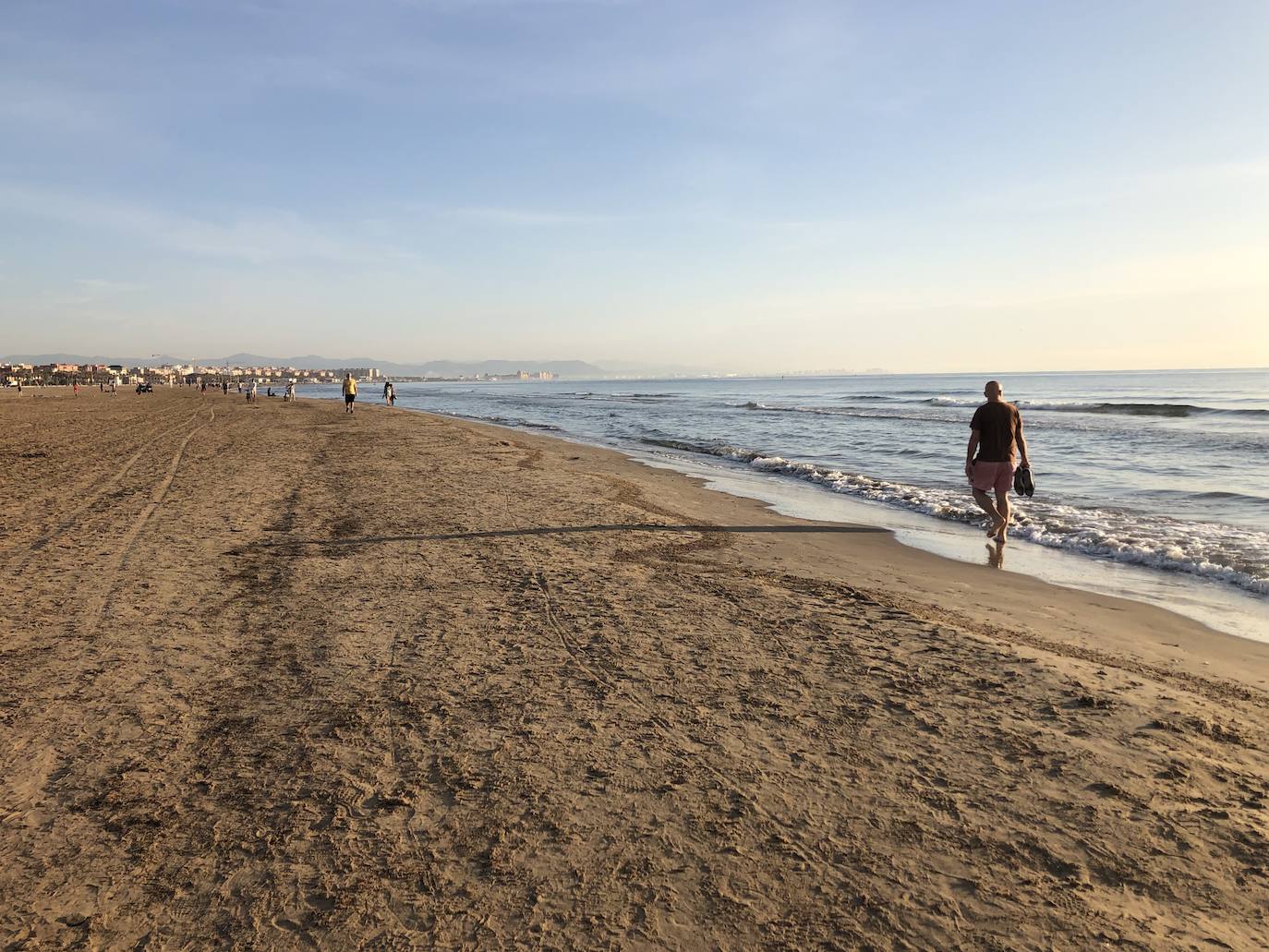 Nadadores, corredores, surfistas y personas practicando yoga se han dejado ver este jueves en las playas de Valencia desde que se ha asomado el sol, aprovechando las horas permitidas para practicar deporte en la ciudad. 