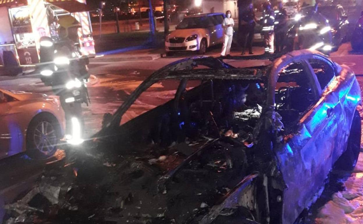 Vehículo calcinado tras el incendio en el aparcamiento exterior del Hospital La Fe. 