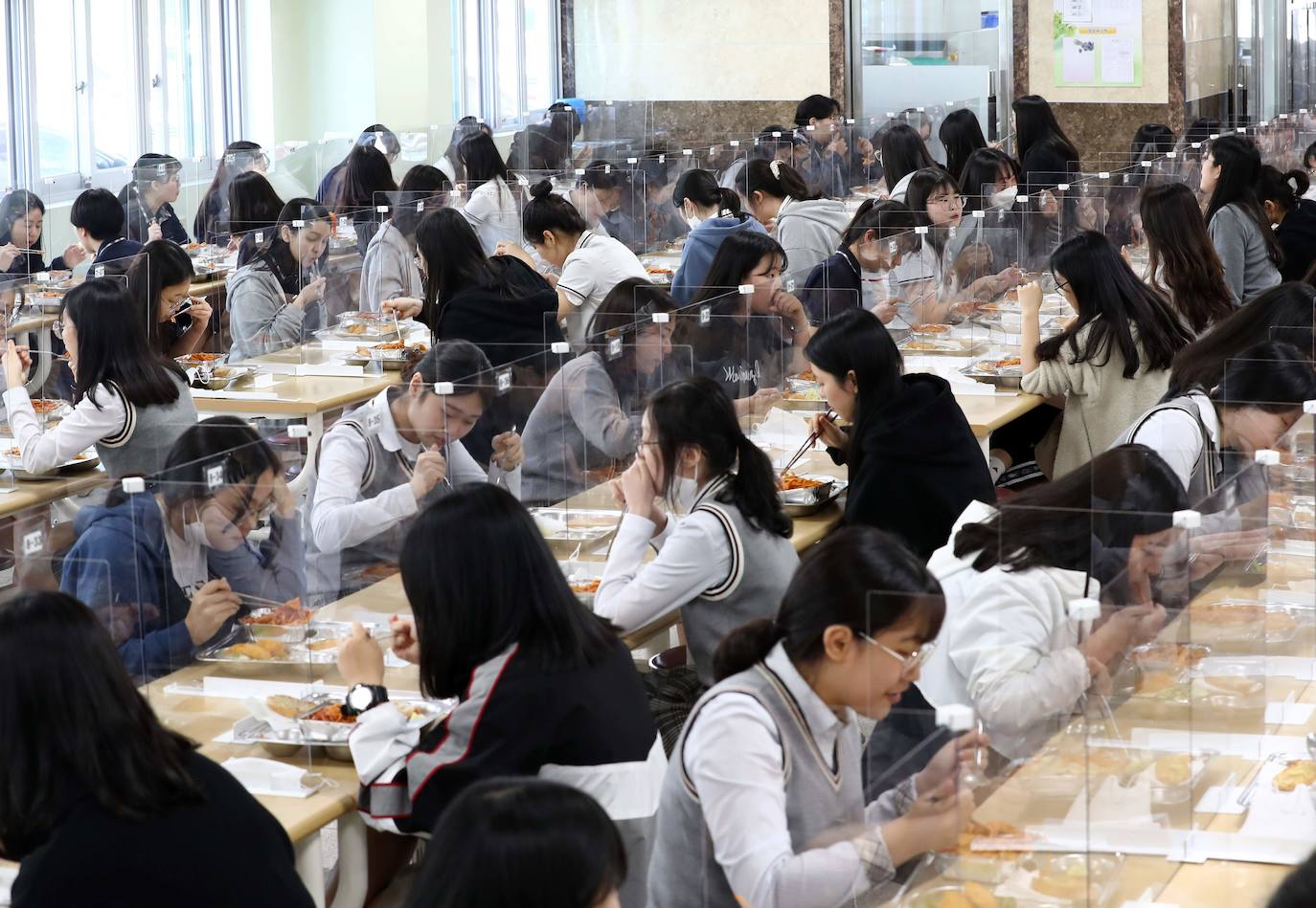 Corea del Sur, uno de los primeros países infectados por el coronavirus que surgió en la ciudad china de Wuhan, está recuperando poco a poco la normalidad. Muestra de ello ha sido el regreso a las clases de sus estudiantes. Los primeros en volver a los pupitres han sido los alumnos de bachillerato; el resto se irá incorporando poco a poco. No obstante, el inicio del curso escolar se ha hecho con una serie de medidas para evitar los contagios entre los estudiantes: el uso de mascarillas en todo momento, limpieza de los pupitres, ventilación continua de los cuartos, mámparas en el comedor y en las mesas y tomas de temperatura al entrar al colegio, todo ello, manteniendo las distancias de seguridad. 