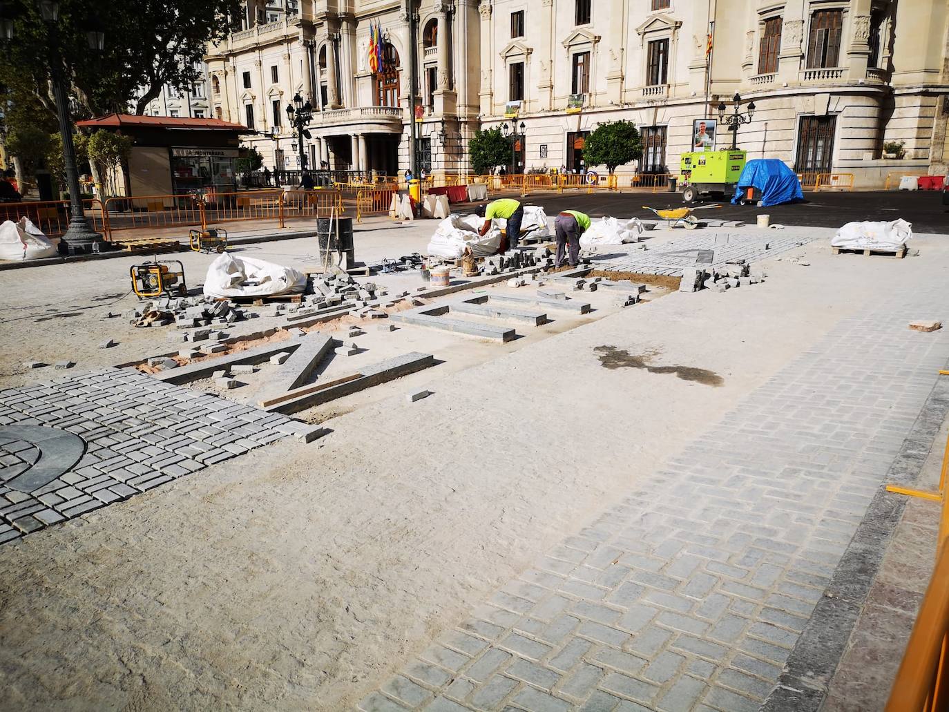 Avanzan las obras en la plaza del Ayuntamiento. El color rojo se apodera de buena parte del pavimento y el nombre de Valencia asoma ya en la zona adoquinada. 