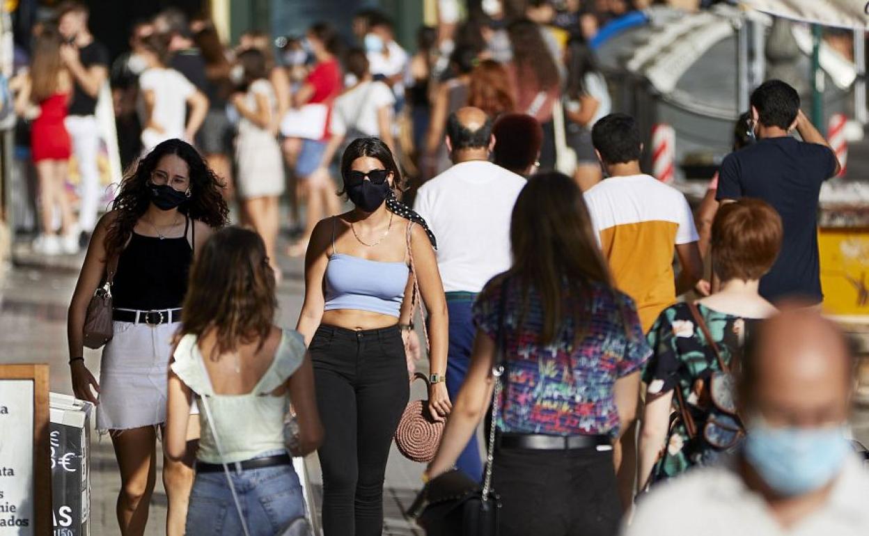 Ciudadanos caminando por las calles de Valencia.