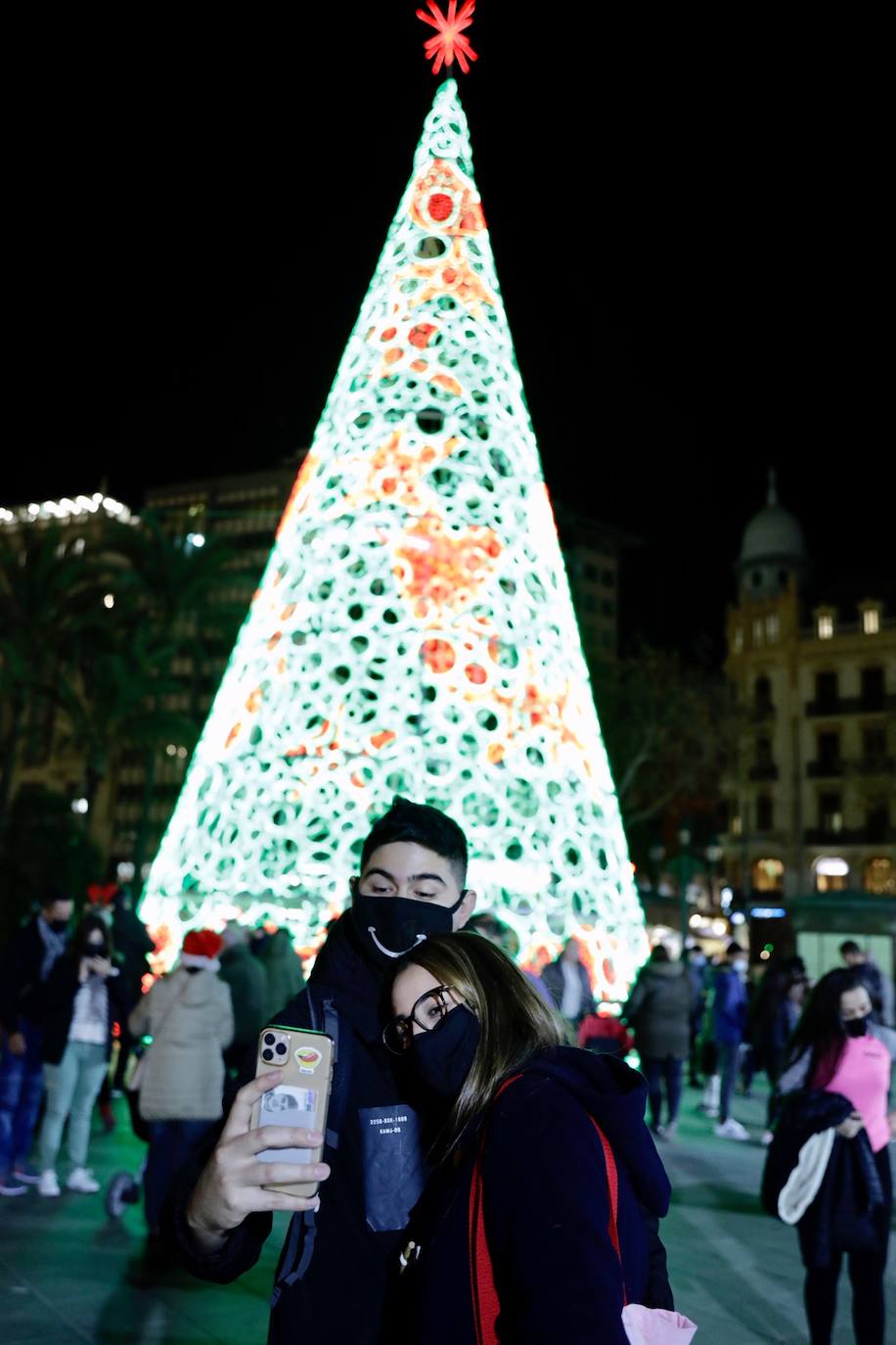 El alcalde Ribó ha asistido esta tarde al encendido en la plaza del Ayuntamiento, acompañado por las falleras mayores de Valencia, Consuelo Llobell y Carla García. La iluminación se estrena en la ciudad con quejas por el escaso gasto frente al aumento en otras ciudades para ayudar al comercio.