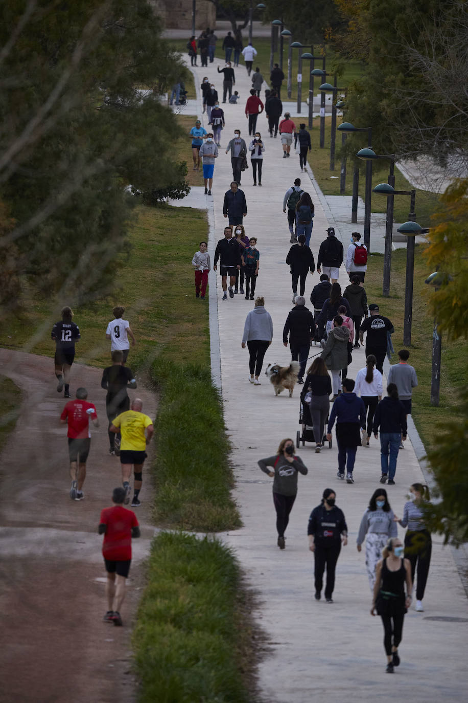 Cientos de personas bajan a diario al viejo cauce tras el cierre de los bares. Comer en el césped, entrenamiento físico o quedar con amigos son las alternativas de recreo en una ciudad sin gimnasios ni restaurantes abiertos. 