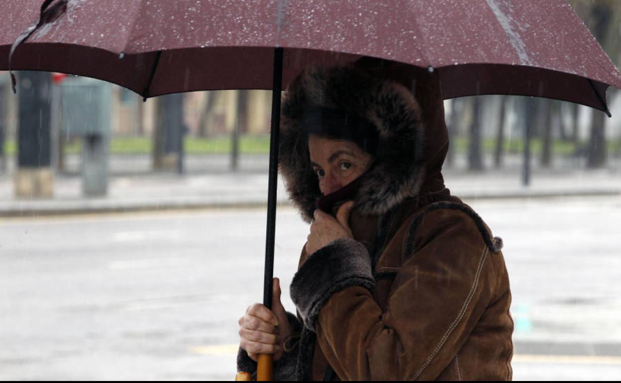 Mujer con paraguas en una calle de Valencia.