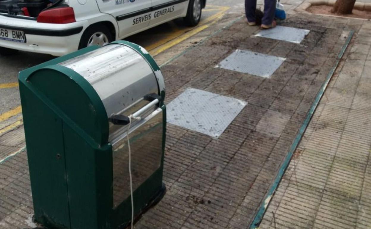 Un trabajador del servicio de limpieza de Teulada Moraira junto a un contenedor de basura.