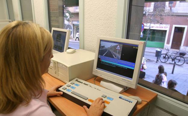 Una alumna completa un test en el ordenador de una autoescuela. 