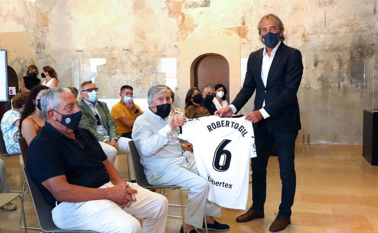 Roberto Gil toma la camiseta con el 6 a la espalda de manos de Ricardo Arias, a su izquierda, Claramunt. 