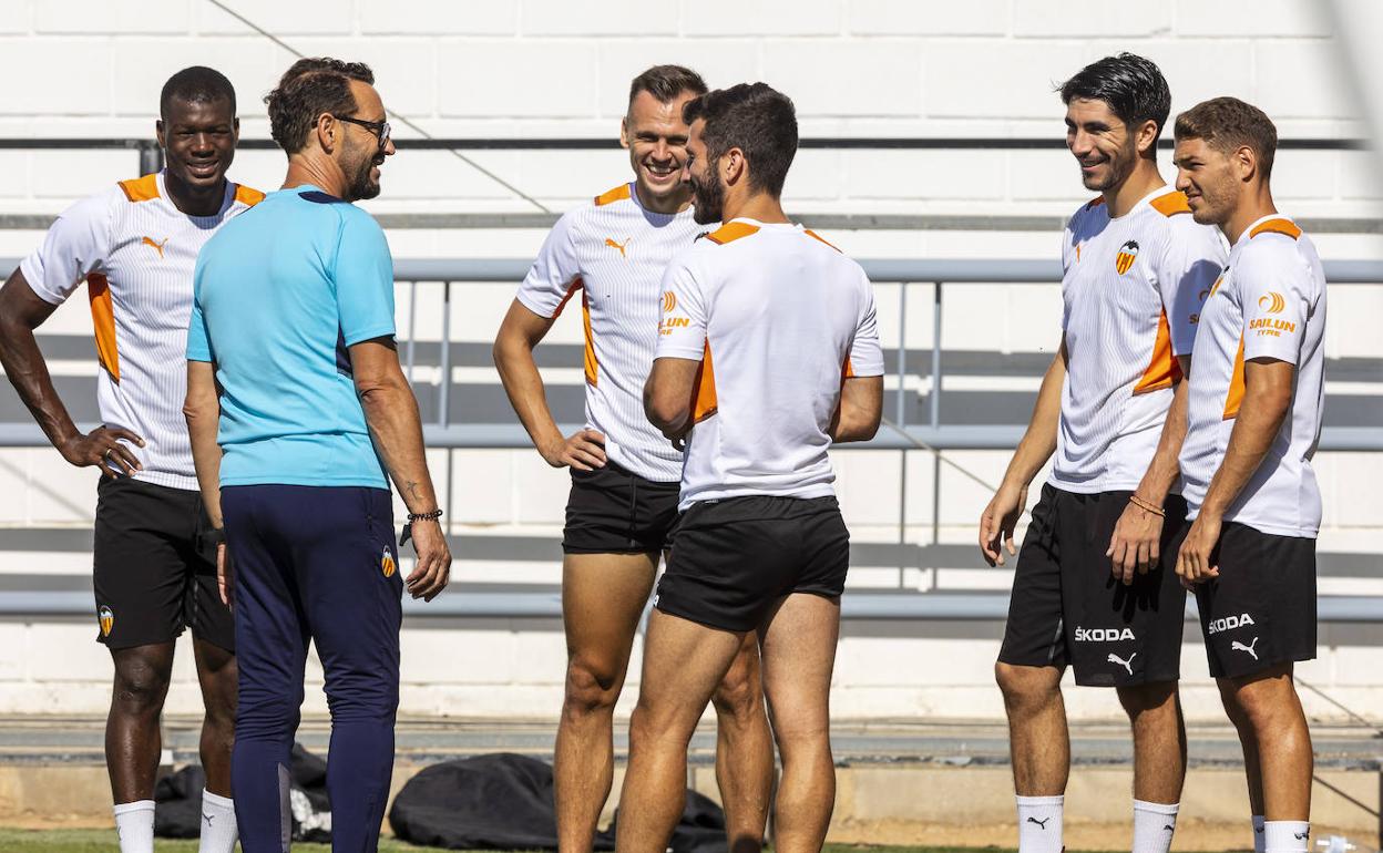 Pepe Bordalás dialoga sobre el césped de Paterna con alguno de sus jugadores. 