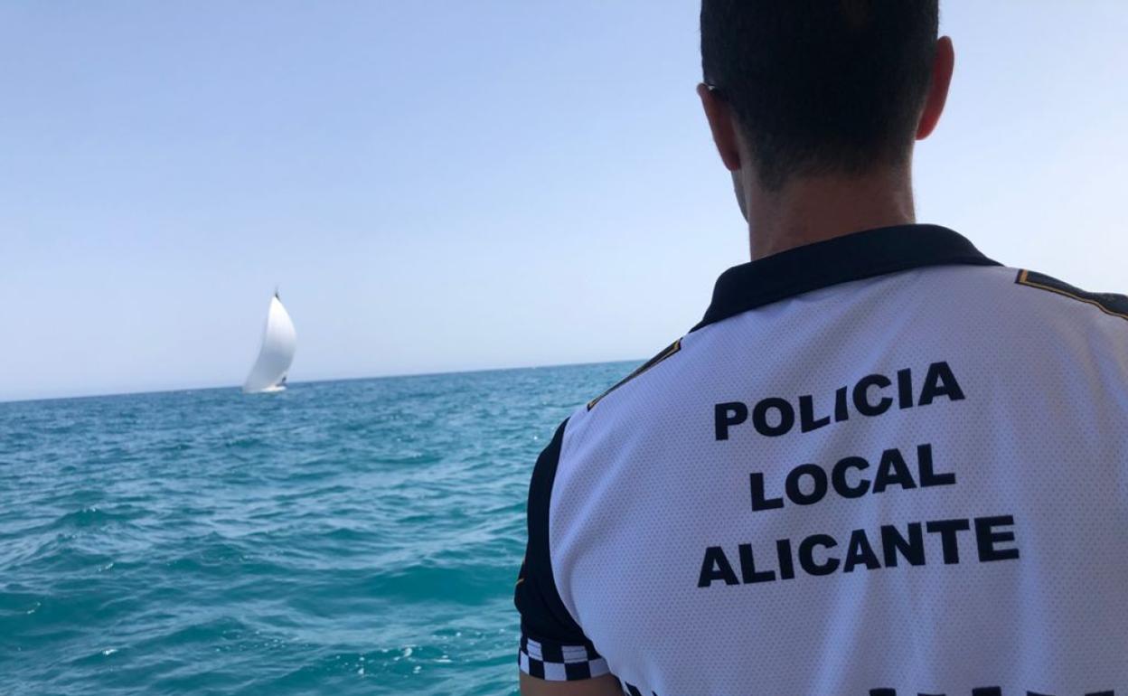 Uno de los agentes busca a la mujer de 40 años ayer en aguas de la costa alicantina.