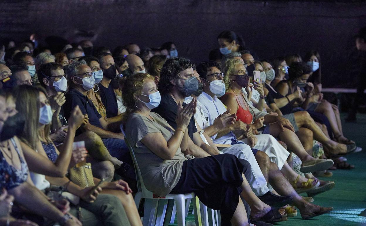 Asistentes a un concierto sentados. 