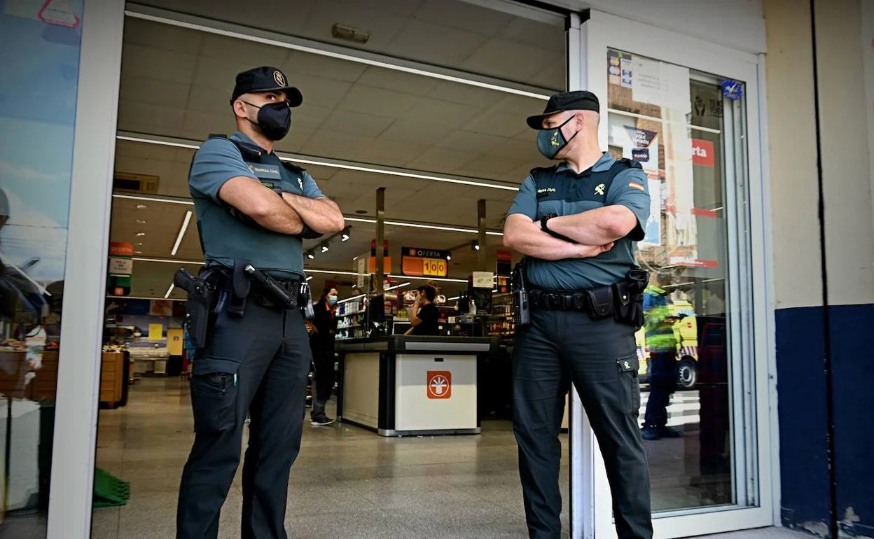 Dos agentes de la Guardia Civil en la entrada de un establecimiento, en una imagen de archivo. 