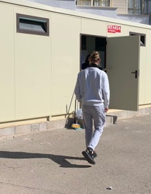 Imagen secundaria 2 - Patio del María Enríquez de Gandia, un docente sale del centro y un joven acude a un baño portátil instalado en el patio del centro, al estar clausurados por obras los baños para chicos. 