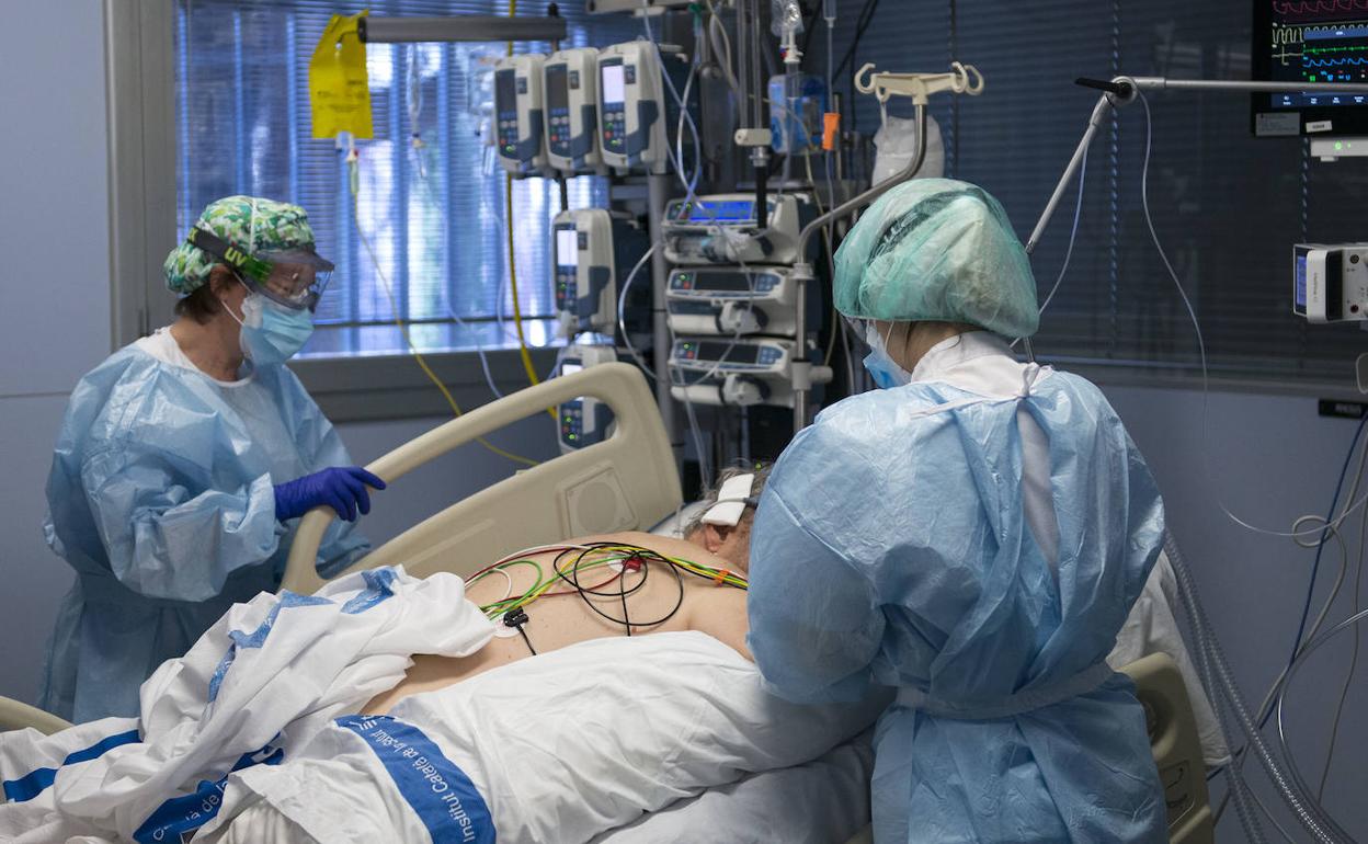 Dos sanitarias atienden a un paciente en la UCI del hospital de Gerona.