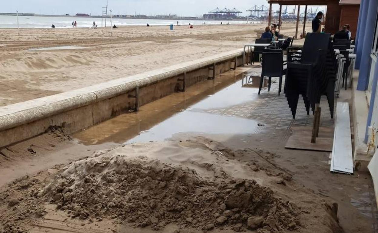 Restos del temporal junto a uno de los restaurantes del paseo marítimo de la Malvarrosa. 