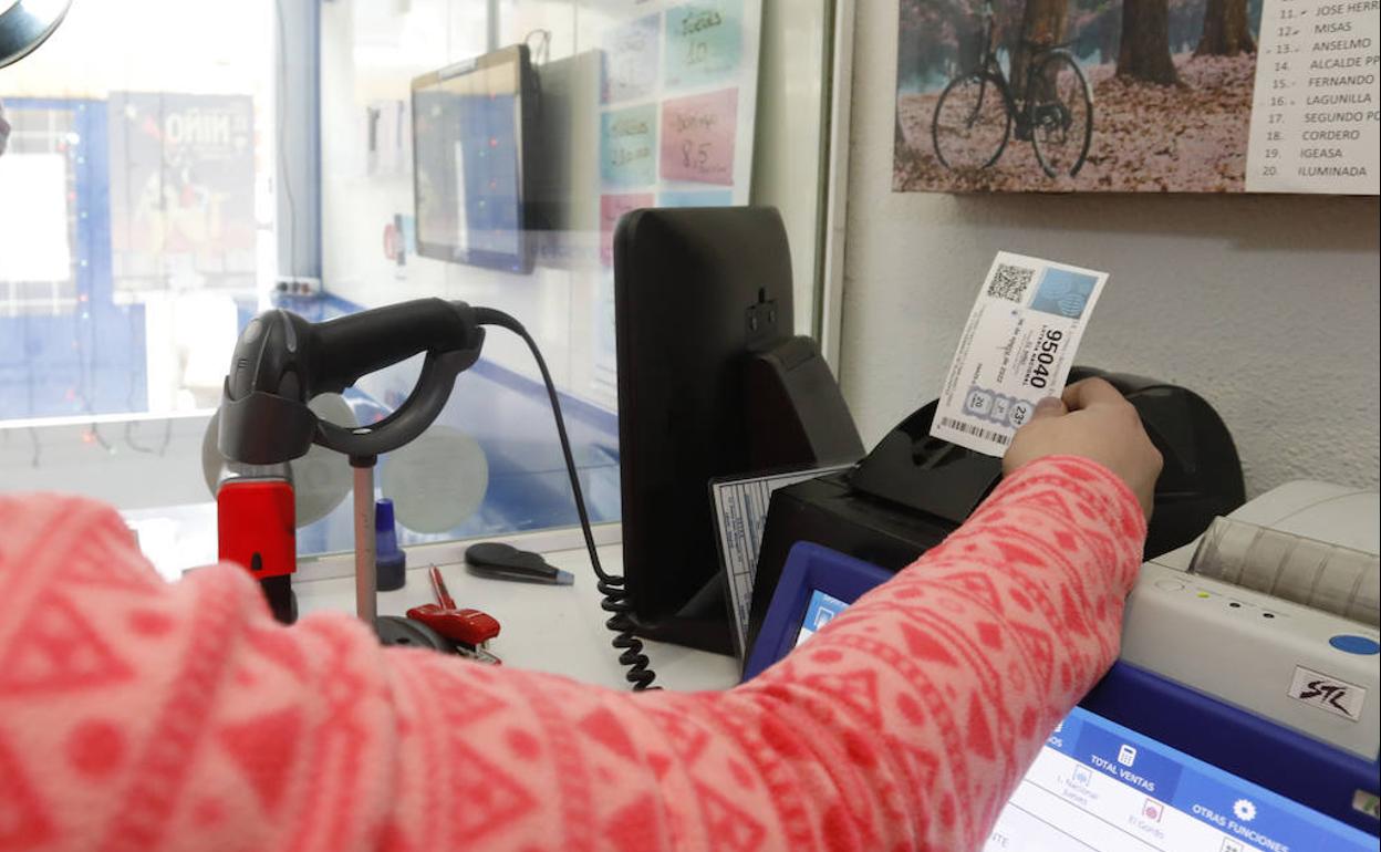 Una mujer comprueba su décimo de lotería. 