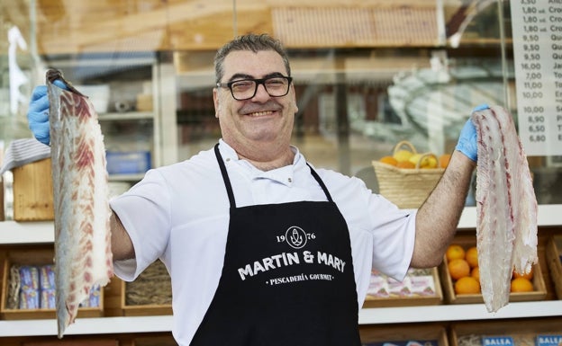 Imagen principal - Arriba, Luis Lázaro, tras filetear la corvina. Abajo, María Llamas, que preparó el plato, que se puede ver a la derecha. 