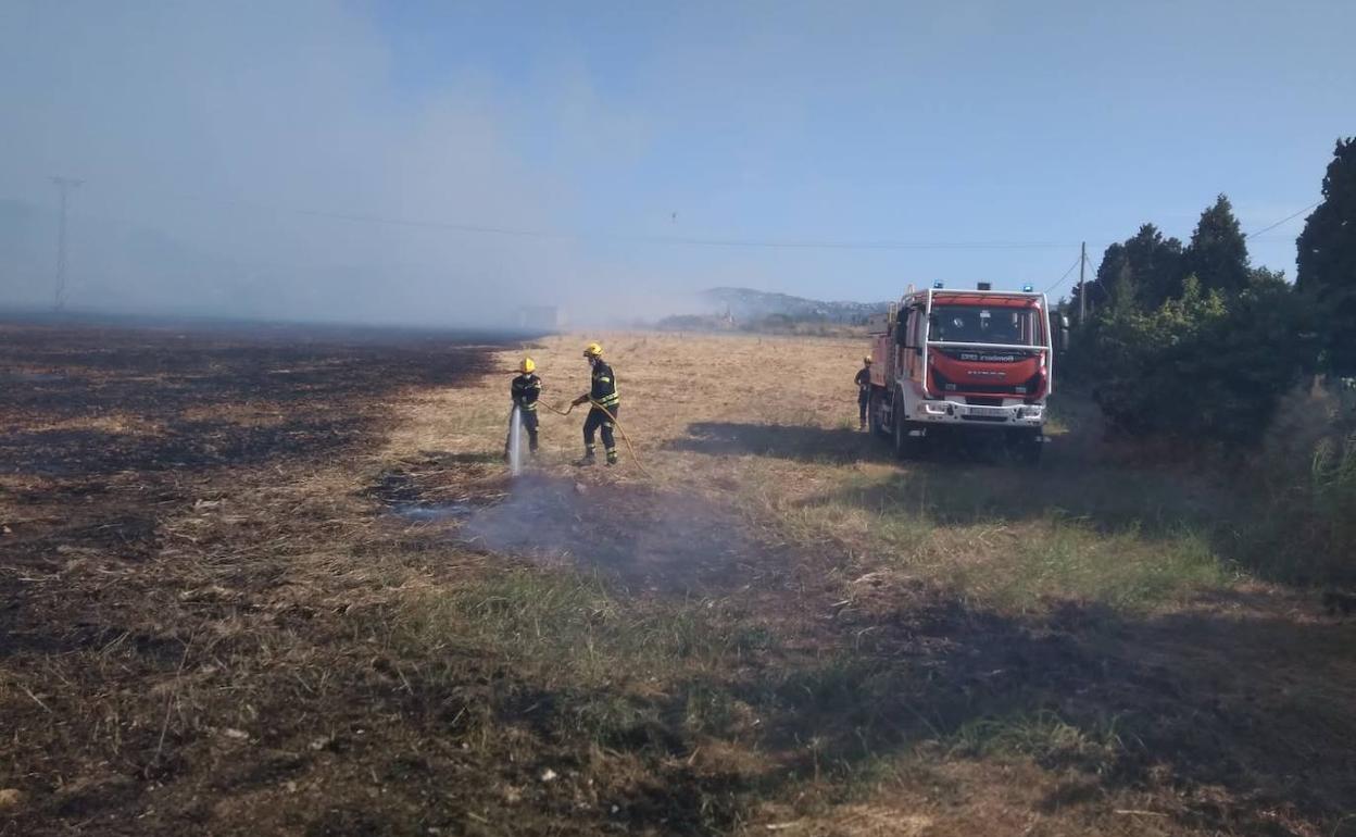 Los bomberos  sofocando el incendio en Dénia. 