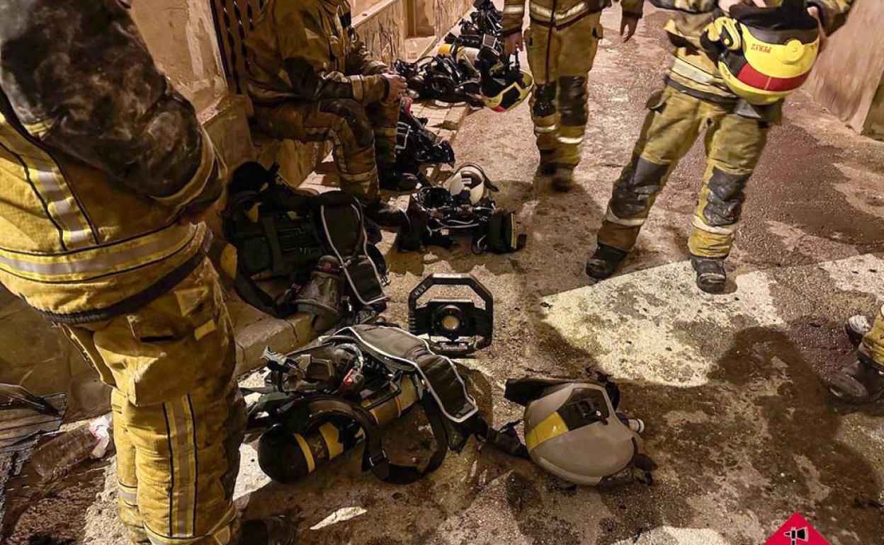 Los bomberos, tras sofocar las llamas en al vivienda de Villena, esta noche. 