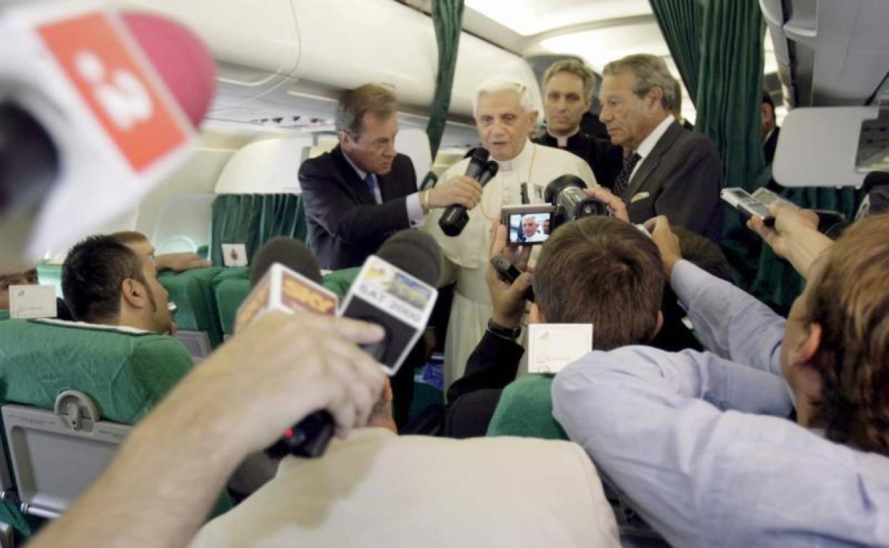 El papa Benedicto XVI (c) habla con los periodistas dentro del avión antes de despegar en Roma con dirección a Valencia, en 2006. 