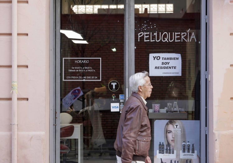 Una peluquería con el cartel que están poniendo los comerciantes.