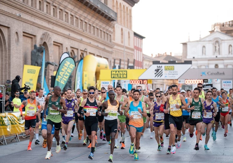 Imagen principal - Salida del Maratón de Zaragoza, y los ganadores de la 10K, Carlos Mayo y Iraia Mendia.