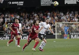 El defensa del Valencia José Gayá pelea un balón con el defensa del Sevilla Jesús Navas