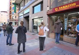 Clientes de un estanco esperando su turno para entrar a comprar tabaco.