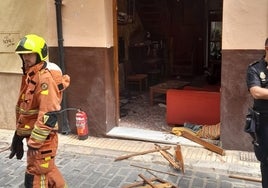 Bomberos y policías junto a los desperfectos de la vivienda de Xàtiva por la explosión de gas.