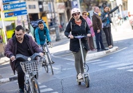 Una mujer monta en patinete eléctrico en Valencia.