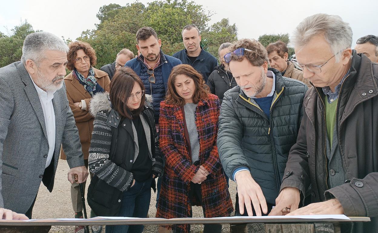 El secretario autonómico de Agricultura junto a autoridades locales observan el plano de los terrenos. 