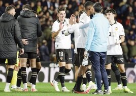 Los futbolistas del Valencia intercambian felicitaciones tras el triunfo contra el Villarreal.