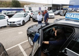 Una mujer prueba un coche de ocasión en un concesionario.