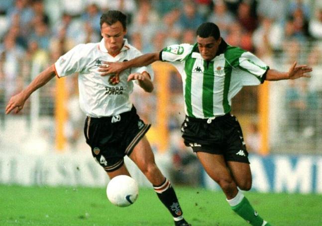 Joachim Bjorklund intentando controlar un balón frente al jugador del Betis Denilson en un partido en Mestalla.