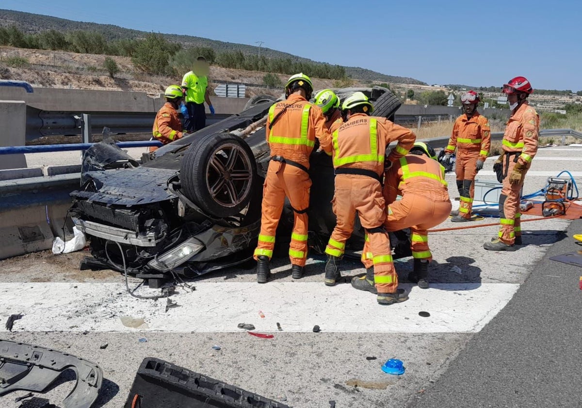 Los bomberos trabajan en el rescate de una de las víctimas del accidente de tráfico de Moixent.