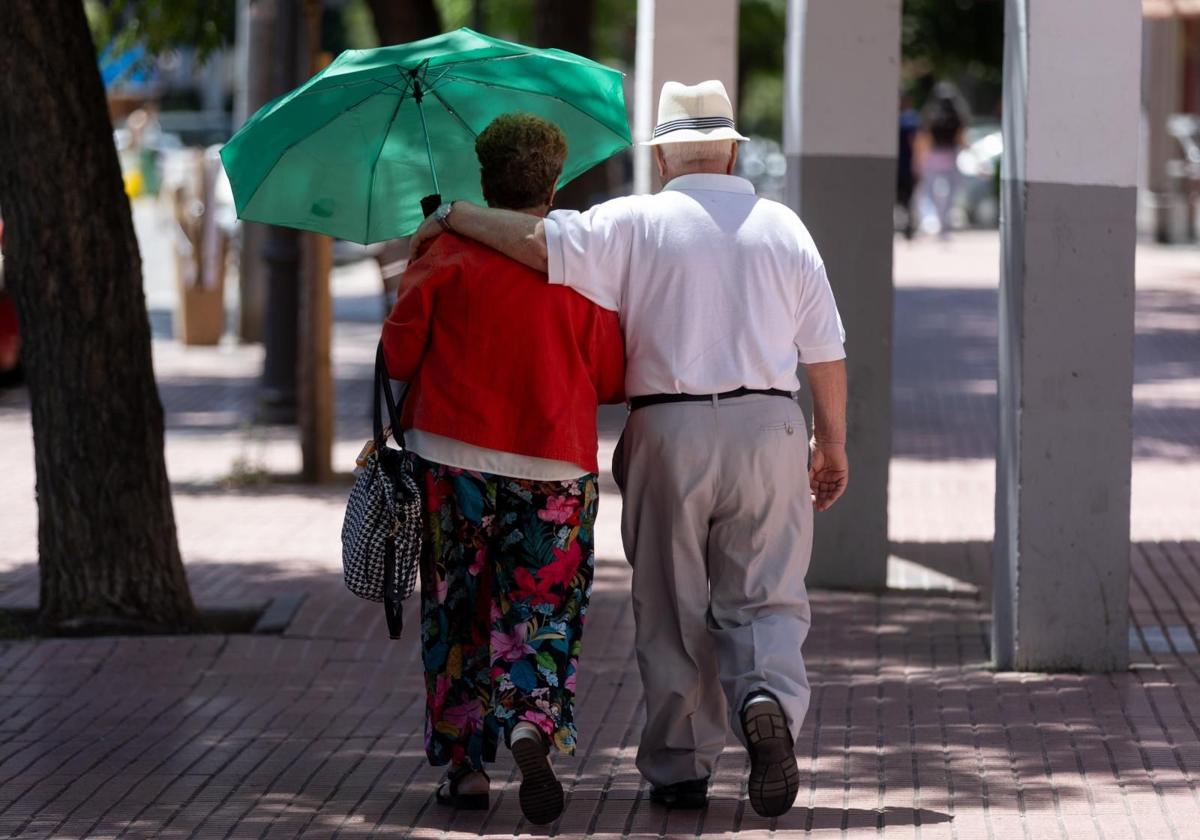 Dos jubilados andan por la calle.