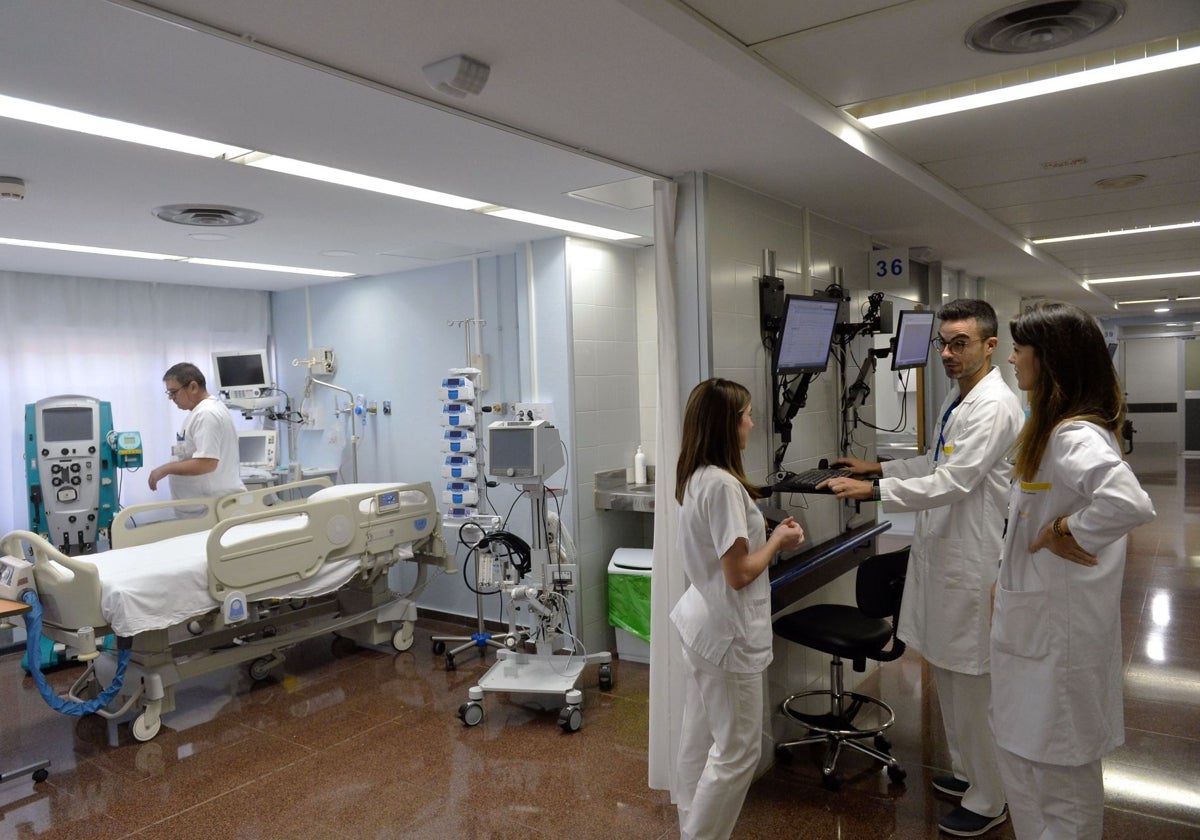 Varios médicos y sanitarios en una sala de un hospital.