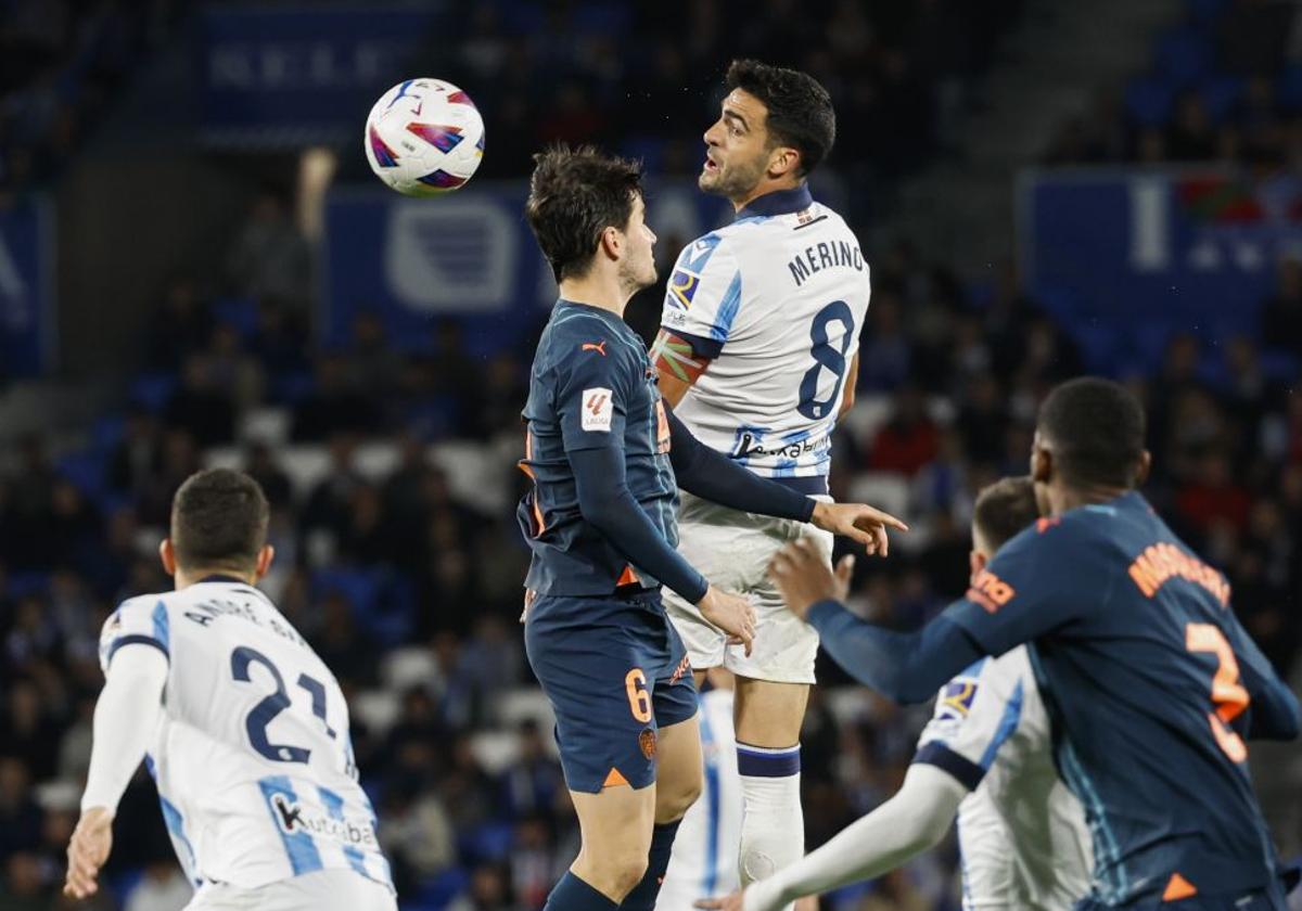 Merino y Guillamon saltan por un balón en el último partido de liga que disputaron Valencia CF y Real Sociedad.