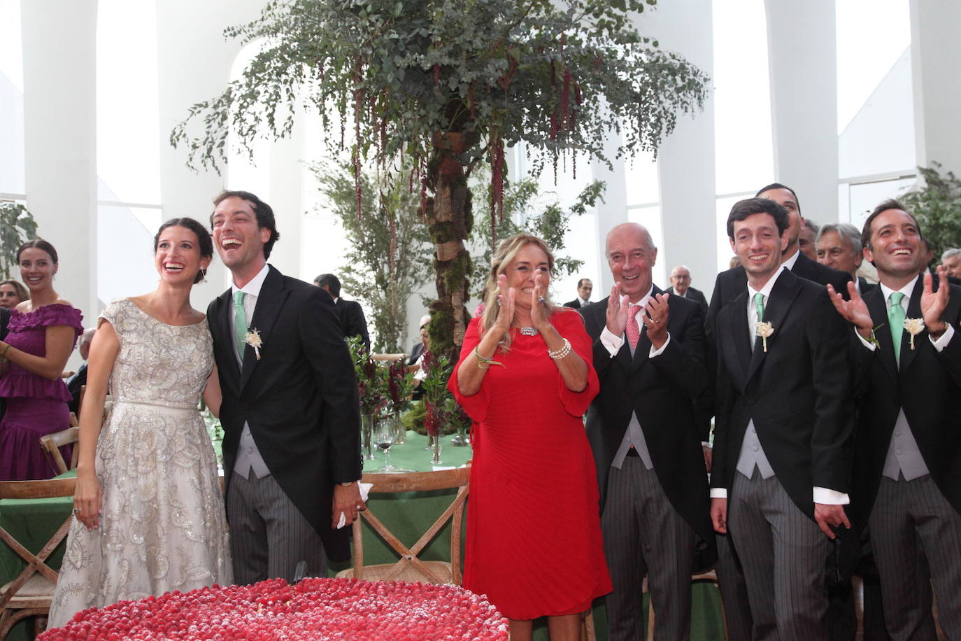 La pareja, con los padres, Enrico y Lilli Lauro, y los hermanos de Giovanni Bonavera. En la parte inferior de la foto se aprecia la tarta nupcial, adornada con seis mil fresones y que viajó desde Genova. 