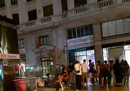 Un grupo de chavales bebe en la entrada al metro de Plaza de España.