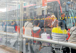 Usuarios de la EMT esperan su autobús en el intercambiador de la calle Xàtiva.