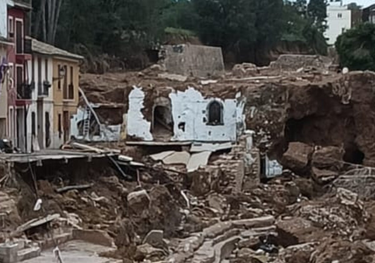 Imagen principal - La calle San Isidro totalmente destruida con la hornacina de la imagen intacta tras el paso de la DANA.