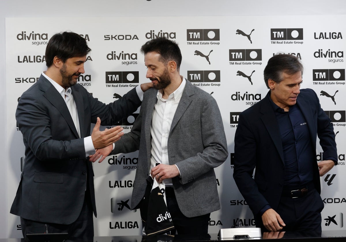 Javier Solís da la mano a Corberán en la presentación de éste, al lado, Corona.