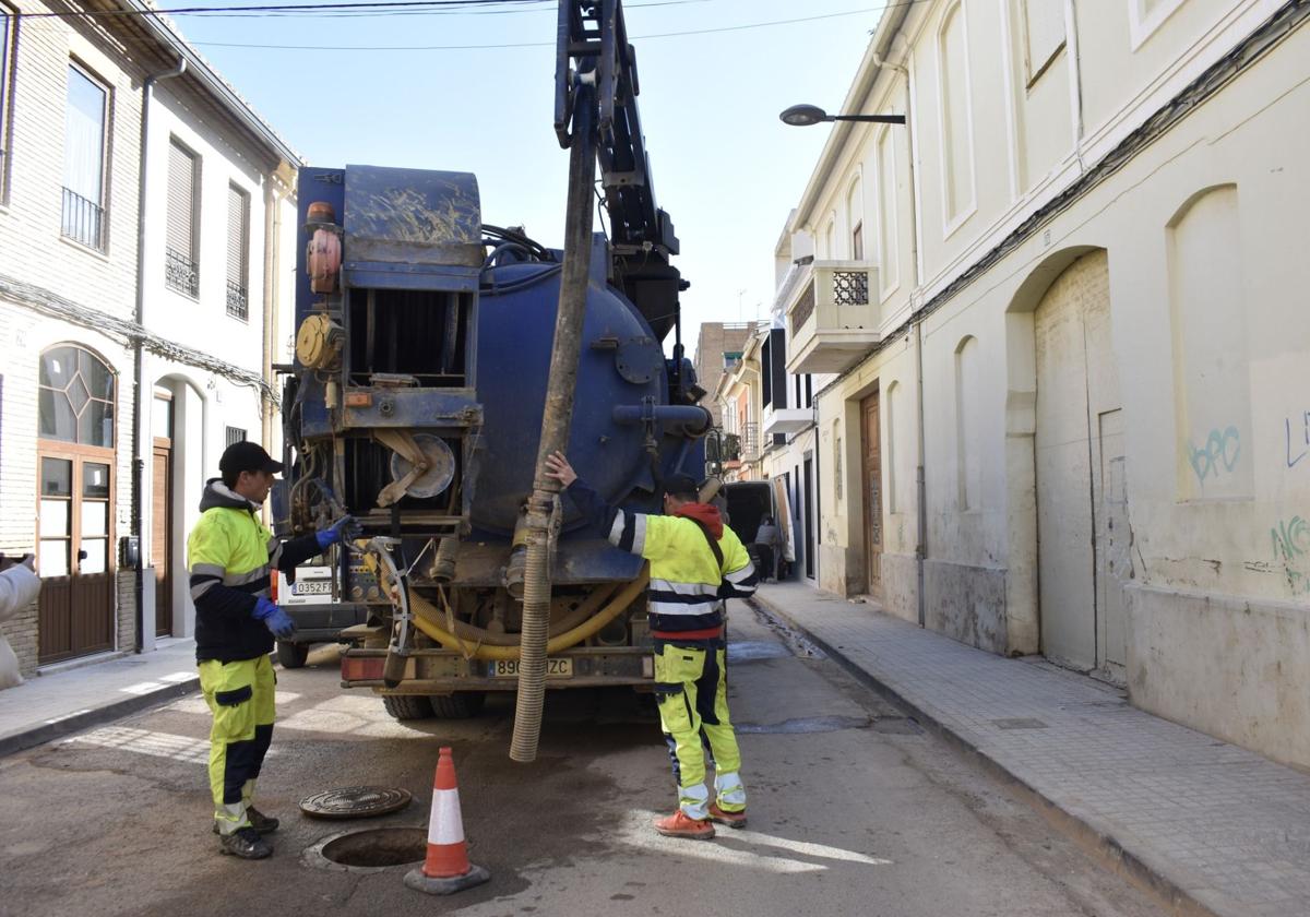 Operarios en la revisión del alcantarillado en una calle de Alfafar.