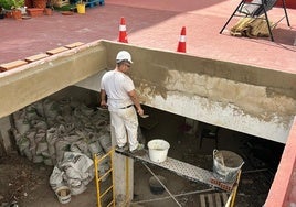 Un trabajador, en uno de los agujeros practicados en el suelo.