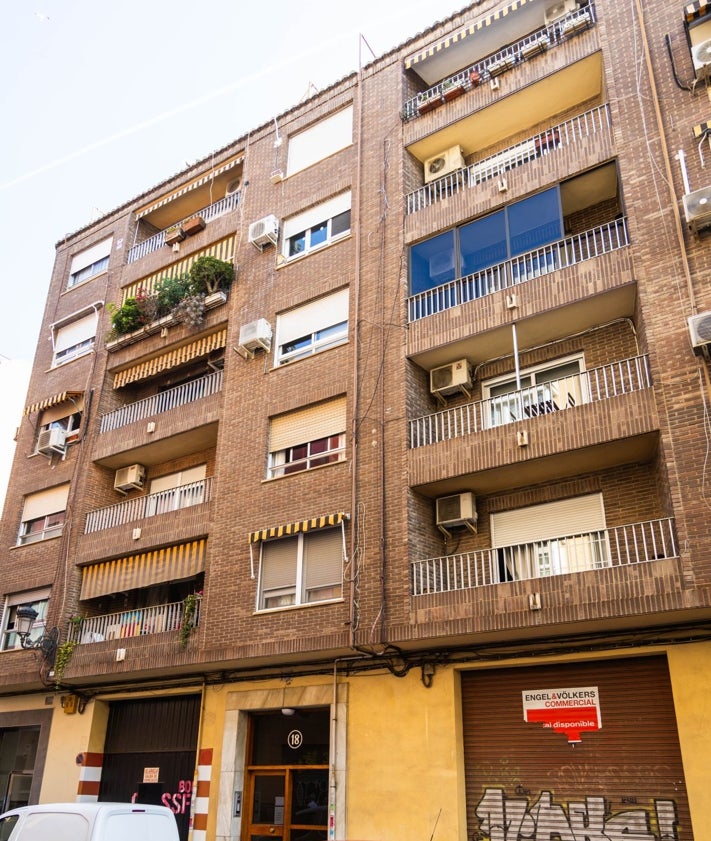 Imagen secundaria 2 - Un hombre camina el viernes junto al garaje donde se cometió el crimen. Abajo, el edificio y la cerradura que abrió Salva con las llaves que le dio Maje para poder acceder.
