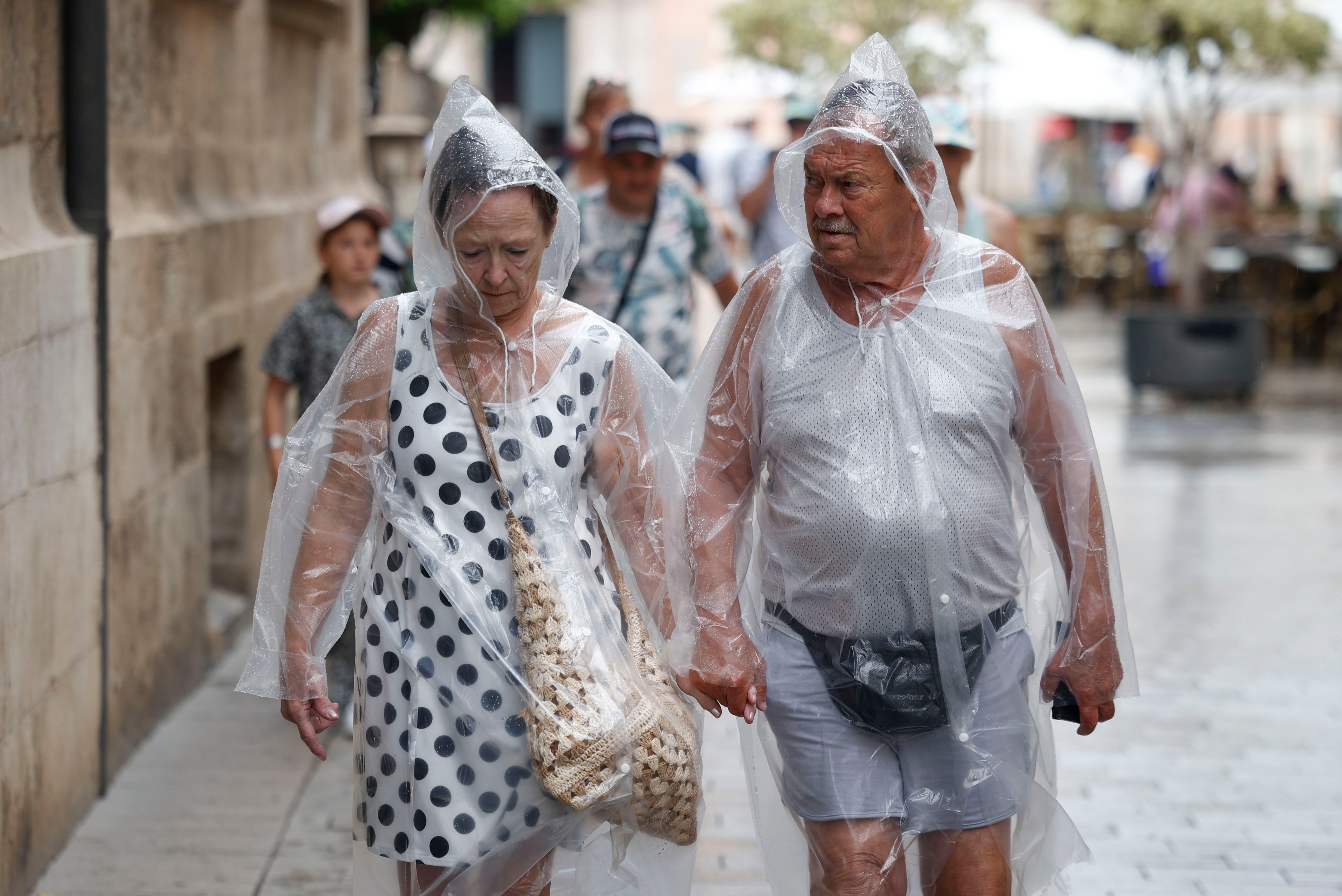 Dos personas se protegen de la lluvia en una imagen de archivo.