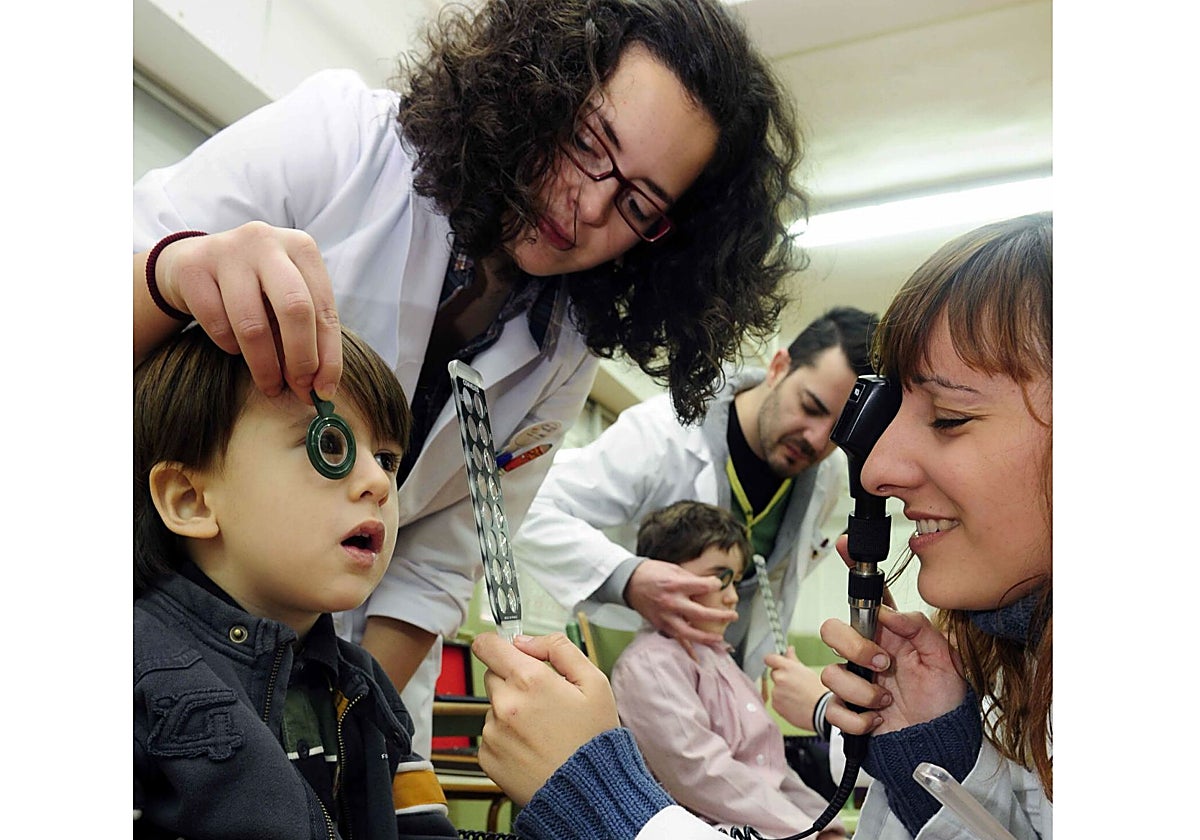 Varios ópticos realizan una revisión en un colegio.