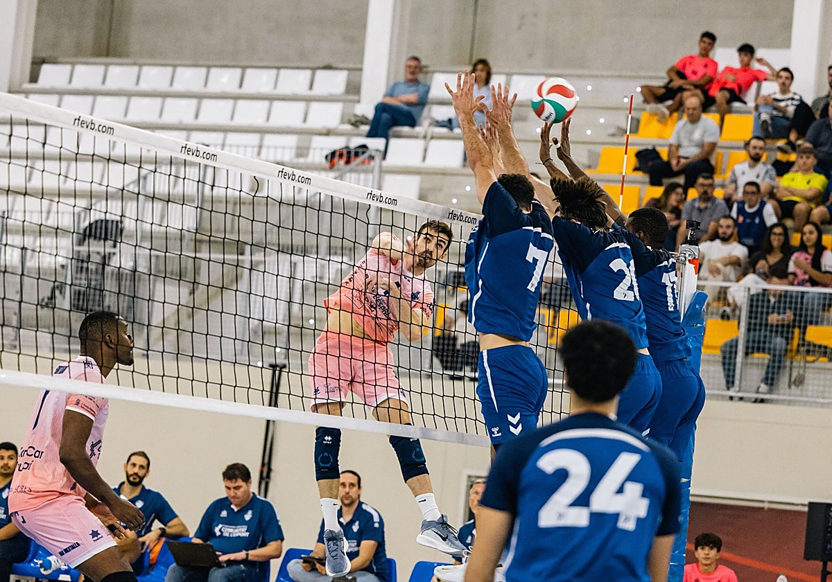 Javi Monfort trata de superar el triple bloqueo del rival.