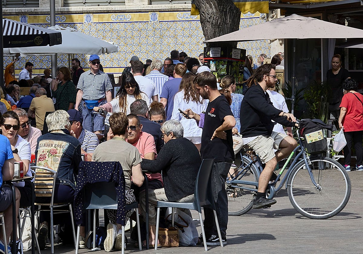 Un camarero atiende a una mesa en una terraza del centro de Valencia.