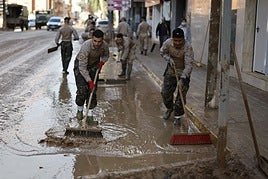 Militares retiran el barro de las calles.